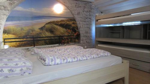 a bedroom with a bed and a painting on the wall at Nature House Arany in Zalaszentgrót