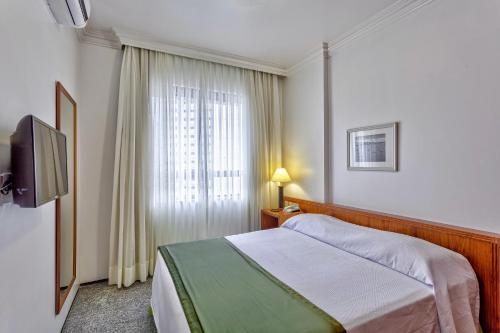 a hotel room with a bed and a window at Tulip Inn Fortaleza in Fortaleza