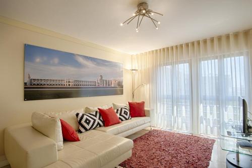 a living room with a white couch and a large window at Green Executive Apartment in the heart of Lisbon in Lisbon