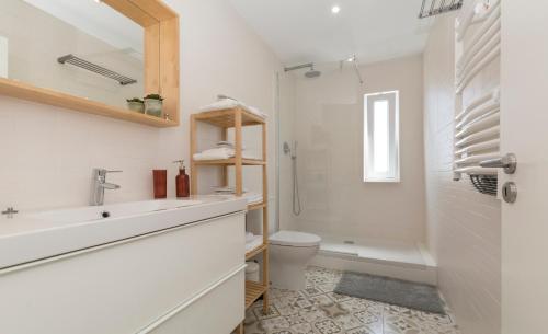 a bathroom with a sink and a toilet and a shower at OrangeTreeHouses in Montijo