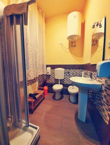 a bathroom with a sink and a toilet and a shower at A un passo dal centro in Palermo