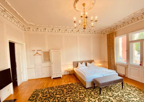 a bedroom with a bed and a chandelier at Villa Antonia in Bautzen