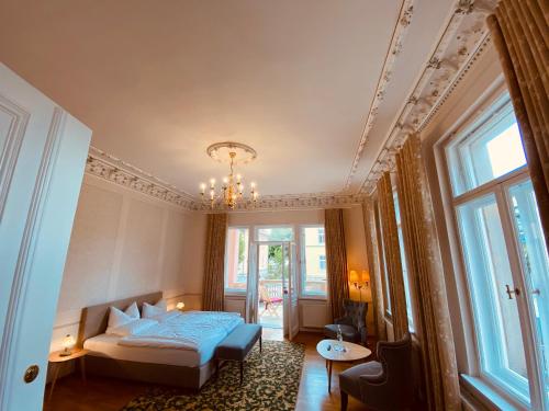 a bedroom with a bed and a chandelier at Villa Antonia in Bautzen