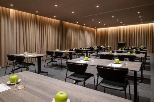 a dining room with tables and chairs with apples on them at BessaHotel Baixa in Porto