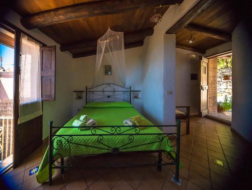 a bedroom with a green bed in a room at B&B La Torretta in Maratea