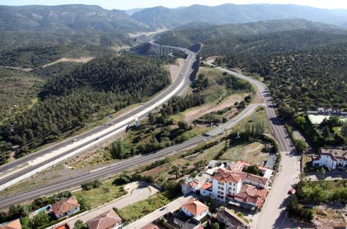 an aerial view of a highway with houses and mountains at El Mesón de Despeñaperros in Santa Elena