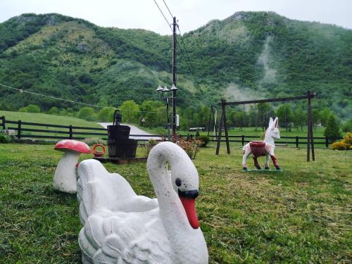 a toy swan and a horse in a park at Romantika in Šavnik