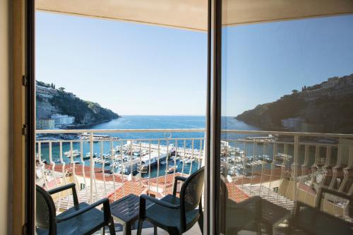 a balcony with chairs and a view of a marina at Coltur Suites in Sorrento