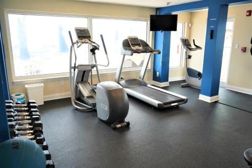 a gym with treadmills and ellipticals in a room at Glunz Ocean Beach Hotel and Resort in Marathon