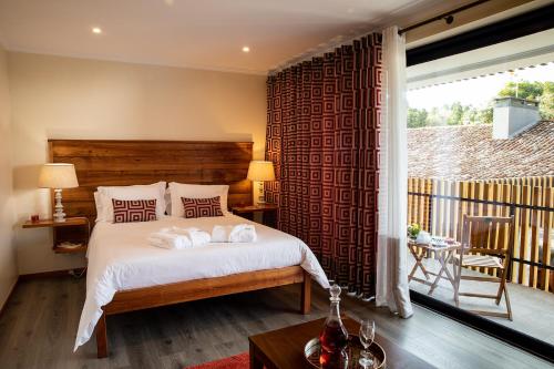 a bedroom with a bed with two towels on it at Sete Cidades Quinta Da Queiró in Sete Cidades