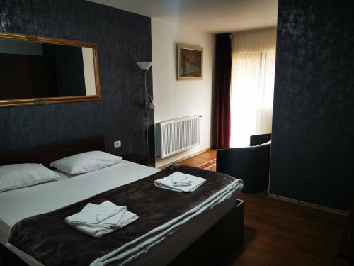 a hotel room with a bed with towels on it at Casa de Vacanta Predeal in Predeal