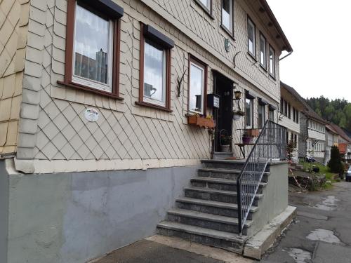 a building with a staircase leading to the door at Haus Bösenberg in Altenau