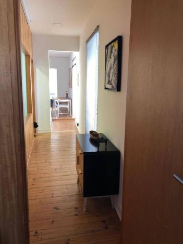 a hallway with a room with a table and a room with a hallway at Casa do Rio - Riverside House in Seixal
