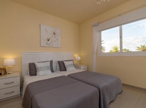 a bedroom with a large bed and a window at Villa Sue in Palm-mar