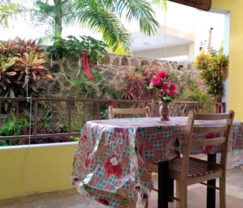 a table with a table cloth on it with two chairs at Charming Apartment in Pereybere with Shared Pool, 75 m² in Pereybere