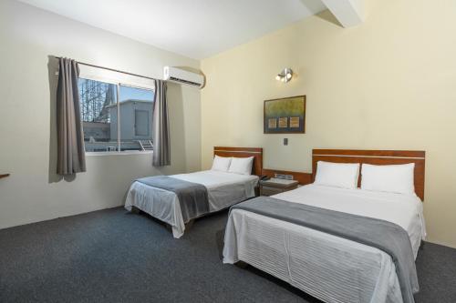 Кровать или кровати в номере Hotel Plaza del Arco - Monterrey