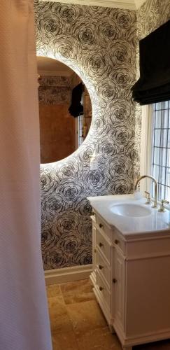 a bathroom with a sink and a mirror at The Jane Toronto in Toronto