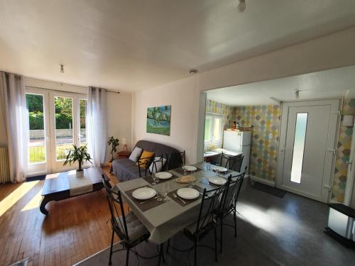 un salon avec une table et des chaises et une cuisine dans l'établissement Santa Maria, à Saint-Ouen-de-Mimbré