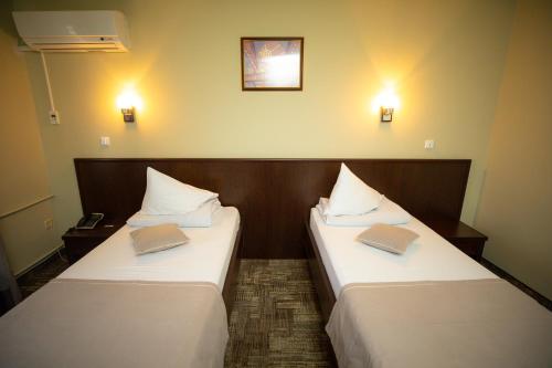 Postel nebo postele na pokoji v ubytování Hotel Select Slobozia
