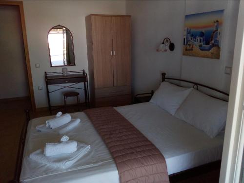 a bedroom with a bed with two towels on it at MARGARITA'S-STUDIOS in Koufonisia