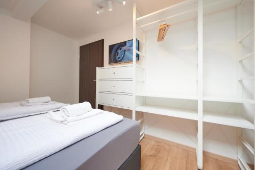 a bedroom with two beds and a closet at Apartments at Winterhafen in Linz