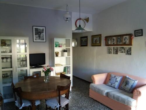 uma sala de estar com uma mesa e um sofá em La casa di Nonna Nilla em San Giovanni Bianco