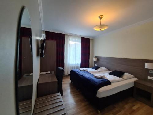 Säng eller sängar i ett rum på Hotel Cara Vita Cologne