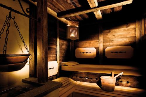 a room with a sauna in a wooden house at Hotel Garni Castel B&B in Ischgl