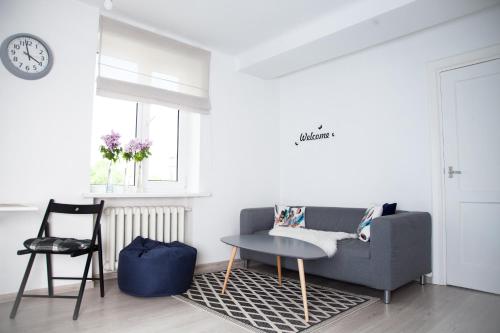 a living room with a couch and a table at Jaukus butas in Kaunas