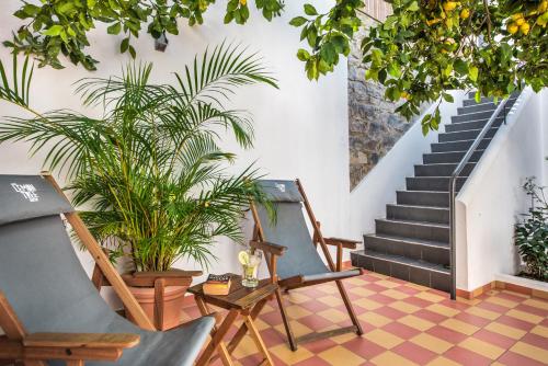 a living room with a staircase and plants at Lemon Tree Stay in Faro