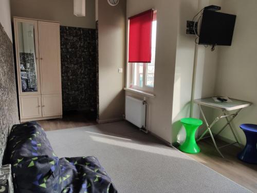 a living room with a green chair and a window at Bambukovyi Gai in Kyiv