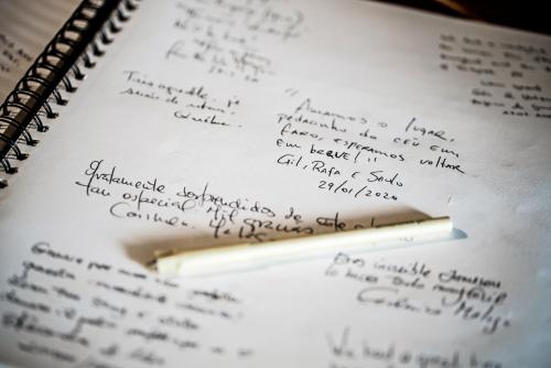 a pencil sitting on top of a notebook with handwriting at Lemon Tree Stay in Faro