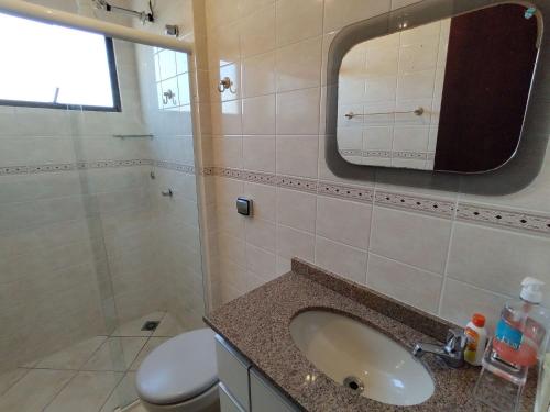 un bagno con lavandino, WC e specchio di Gaivotas · Para você, toda a comodidade da beira da praia. a Matinhos