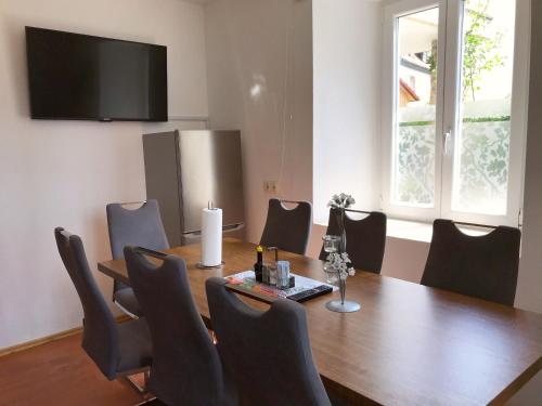 a conference room with a wooden table and chairs at Lotus Home Isny in Isny im Allgäu