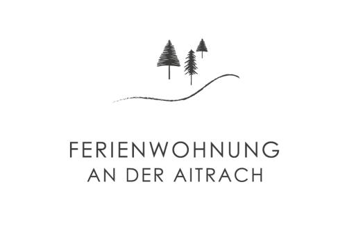 an der aircraft logo with trees and a ribbon at Ferienwohnung an der Aitrach in Aitrach