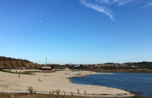 a beach with a group of people on it at Casas da Baronia in Vila Nova da Baronia