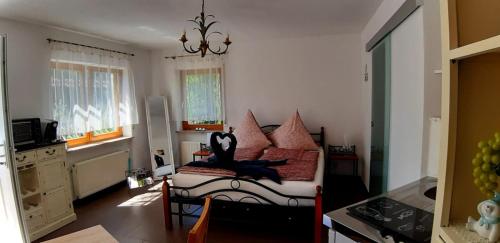 a bedroom with a bed with a monkey sitting on it at "Klein & Fein" in Überlingen