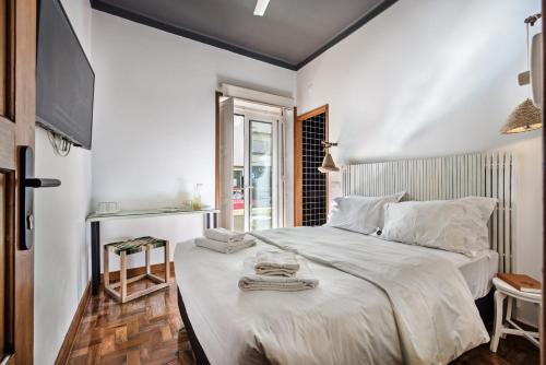 a bedroom with a large white bed with towels on it at Lemon Tree Stay in Faro
