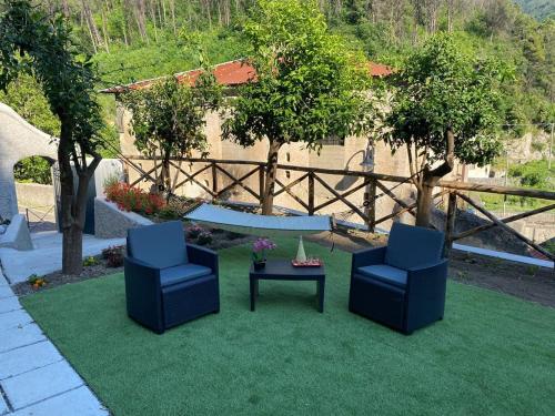 two chairs and a table in a yard at Holiday House Ruocco in Maiori