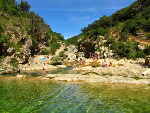 a group of people swimming in a river at Gîte San Jordi in Duilhac
