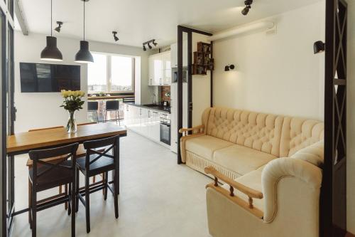 a living room with a large couch and a table at Cozy39 in Kaliningrad