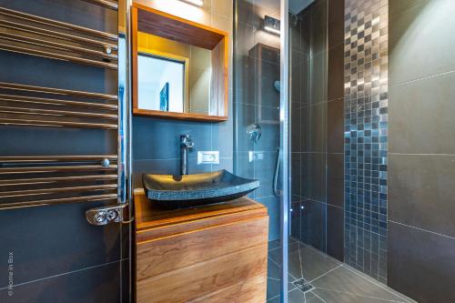 a bathroom with a sink and a shower at Luxurious Tage - Fairytale Factory in Serris
