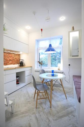 a kitchen with a table and a chair in a room at CERONAV CityCenter Galati, DISSCOUNT on Google! in Galaţi
