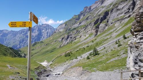 a yellow sign on the side of a mountain at Hotel Beau-Séjour in Leukerbad