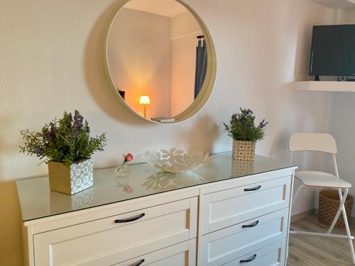 a white dresser with a mirror on the wall at Agios Ioannis luxurious beachfront studio in Agios Ioannis Pelio