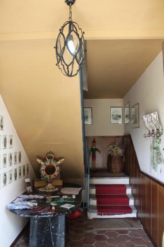 a staircase in a house with a chandelier at Agriturismo La Rovere in Cossano Belbo