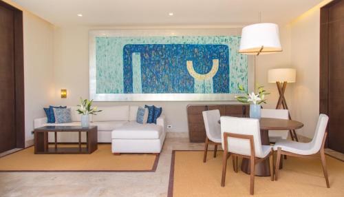 a living room with a couch and a table and chairs at Chablé Yucatan in Chocholá