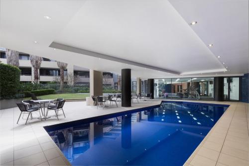 a swimming pool in the middle of a house at Adina Apartment Hotel Sydney, Darling Harbour in Sydney