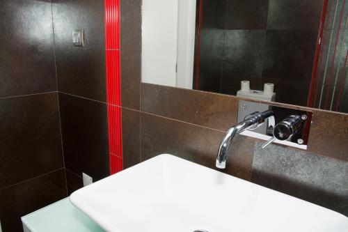 a bathroom with a sink and a mirror at Casas do Regato in Castelo Branco
