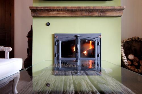 a fireplace with a fire inside of it at Hotel Rural San Giles in Jarandilla de la Vera